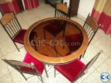 Glass centered round dining table with six chair full set .