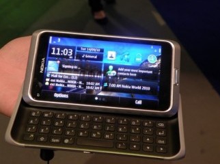 Nokia E7-00 with headphone charger and datacable.
